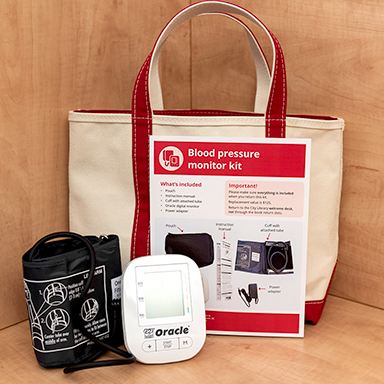 blood pressure kit showing blood pressure monitor, instruction sheet and carrying bag.