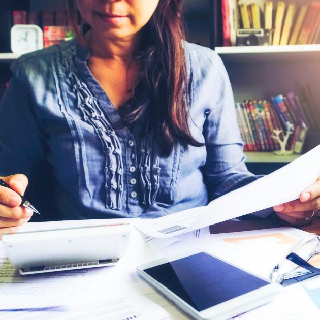 A person sitting at a desk in front of tax papers