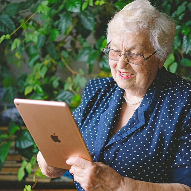 A senior woman with an Ipad