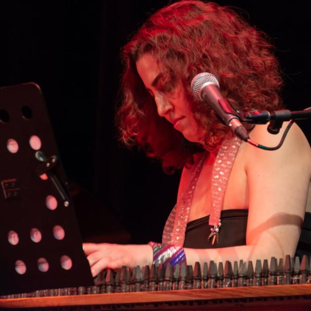 A woman with short hair playing a musical instrument