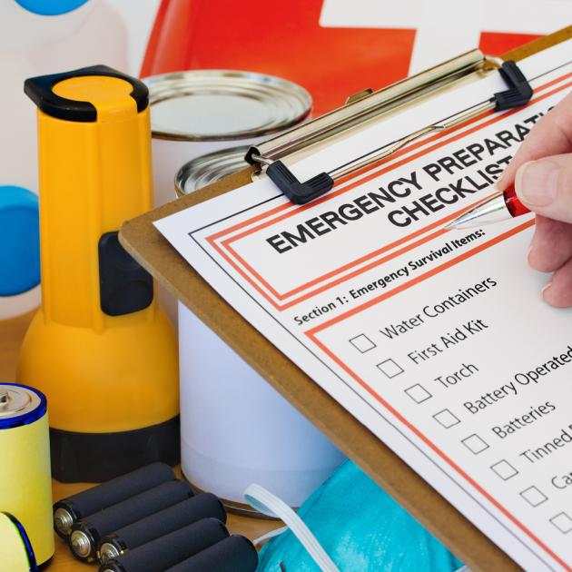 Clipboard with emergency preparation checklist, flashlight and batteries