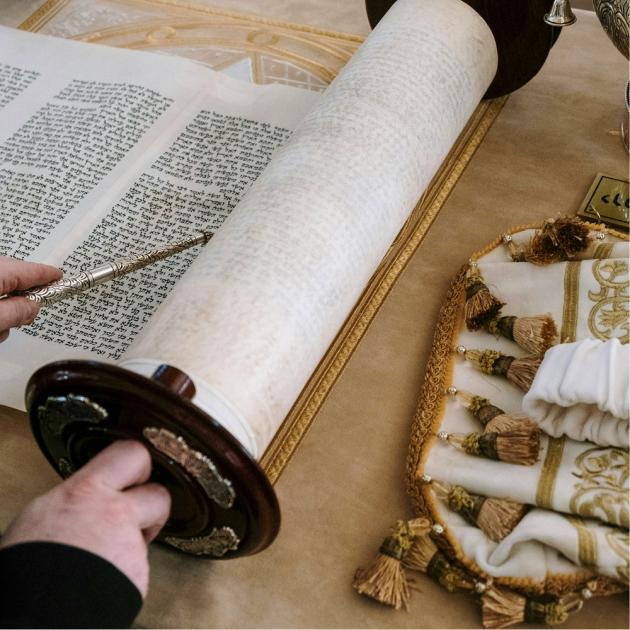 Hand holding Torah scroll 