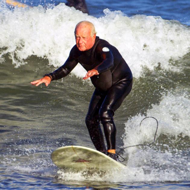 Senior surfing waves